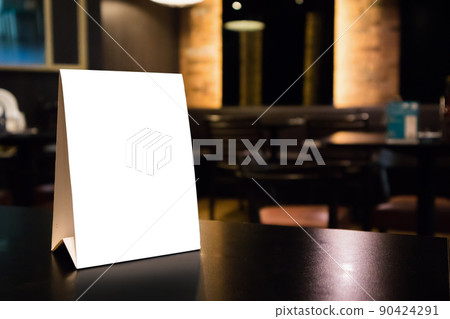 Mockup white label menu frame on table with cafe restaurant interior background Mockup white label menu frame on table with cafe restaurant interior background 90424291