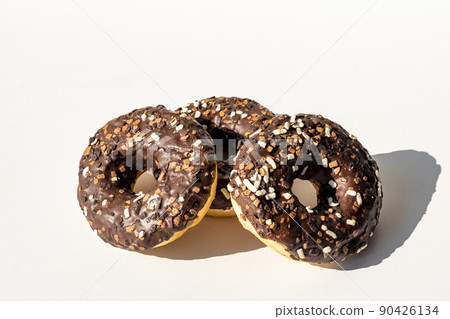 Chocolate donuts. Donuts with colorful sprinkles isolated on white background. Chocolate donuts. Donuts with colorful sprinkles isolated on white background. 90426134