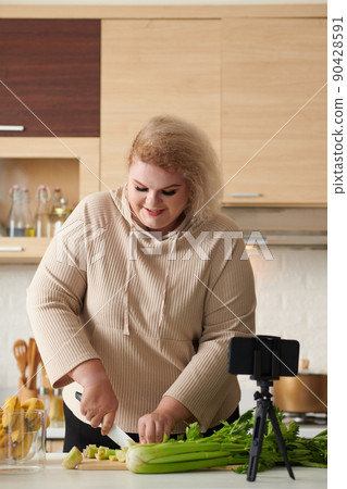 Cheerful Woman Making Lunch Smoothie 90428591
