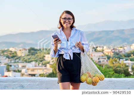 Outdoor portrait of beautiful mature woman, summer nature sky background 90429530