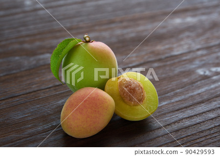 Plum nuts on a wooden table Plum nuts on a wooden table 90429593