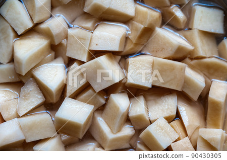 Full frame diced potatoes. Raw vegetable without peel. Healthy Eating. Food, ingredients. Full frame diced potatoes. Raw vegetable without peel. Healthy Eating. Food, ingredients. 90430305