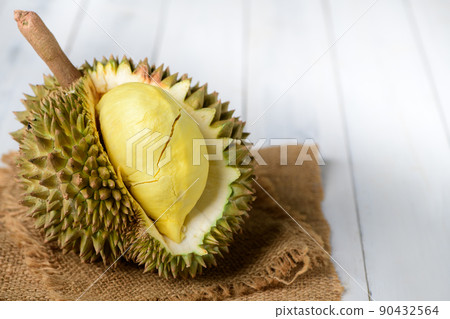 Fresh durian (monthong) on sack and white old wood 90432564