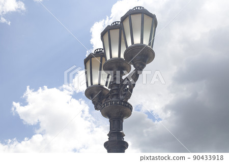 Old vintage street light against blue sky Old vintage street light against blue sky 90433918
