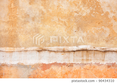 Texture of a plastered old clay wall with cracks and scratches and a split seam between floors. Texture of a plastered old clay wall with cracks and scratches and a split seam between floors. 90434310