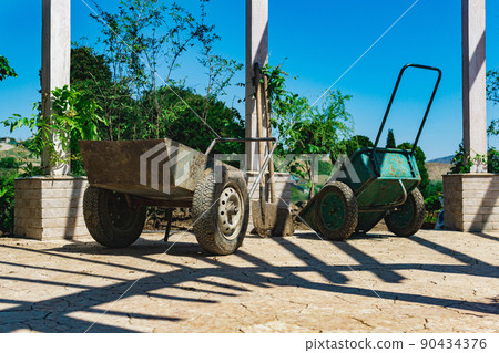 soiled wheelbarrows and shovels at landscaping soiled wheelbarrows and shovels at landscaping 90434376