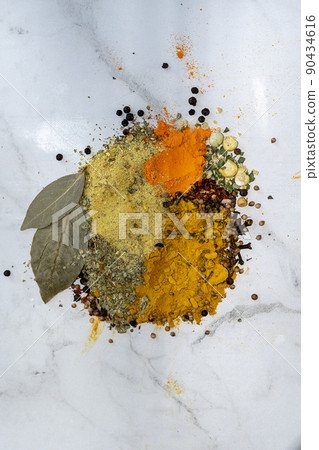 Various herbs and spices for cooking. Spices are scattered on a white background, top view. Various herbs and spices for cooking. Spices are scattered on a white background, top view. 90434616