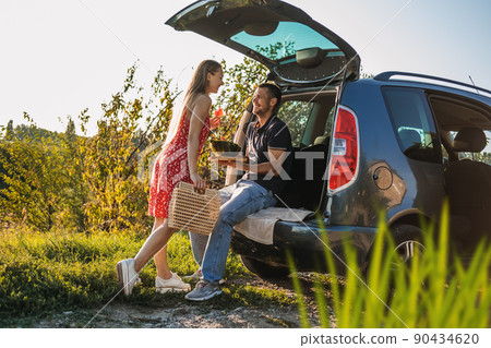 Local travel, Romantic Picnic Date Ideas. couple in love on summer picnic with watermelon in car trunk 90434620