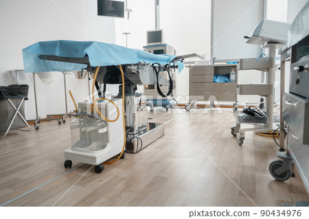 Interior of operation room with different medical equipment ready for surgery Interior of operation room with different medical equipment ready for surgery 90434976
