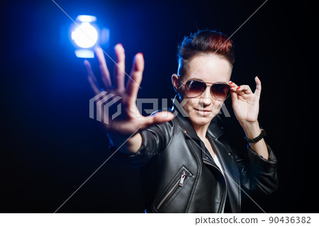 Stylish short haired brunette woman in black leather jacket wearing sunglasses Stylish short haired brunette woman in black leather jacket wearing sunglasses 90436382