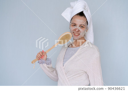 Brunette cheerful caucasian woman sings with refreshing body care spa mask 90436621