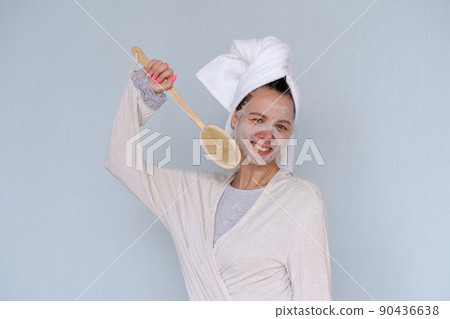 Woman with cosmetic mask on her face, doing anti-aging beauty treatments 90436638