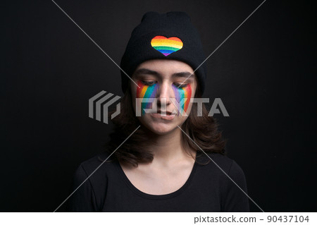 Crying eyes with rainbow iris flag on colored face concept sadness and pain Crying eyes with rainbow iris flag on colored face concept sadness and pain 90437104