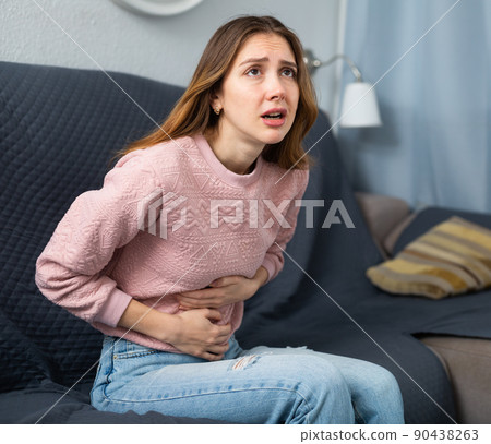 Young woman suffering from abdominal pain Young woman suffering from abdominal pain 90438263