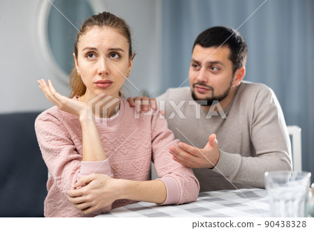 Husband consoling his sad wife 90438328