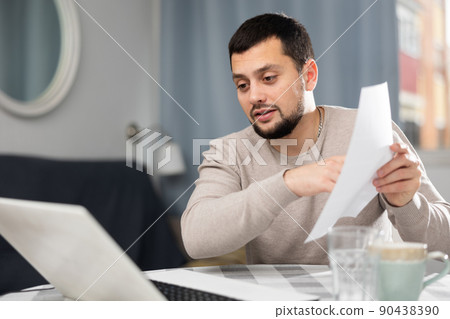 Smiling man chatting online using laptop Smiling man chatting online using laptop 90438390