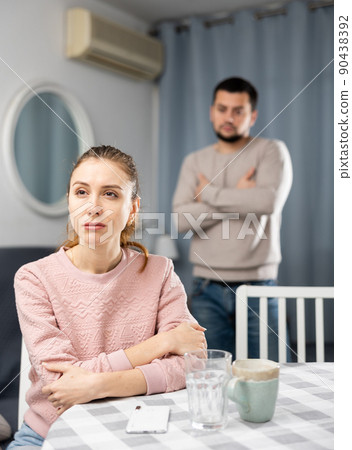 Offended woman sitting at home after spat with boyfriend 90438392