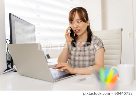 Calling a young female engineer working from home Calling a young female engineer working from home 90440752