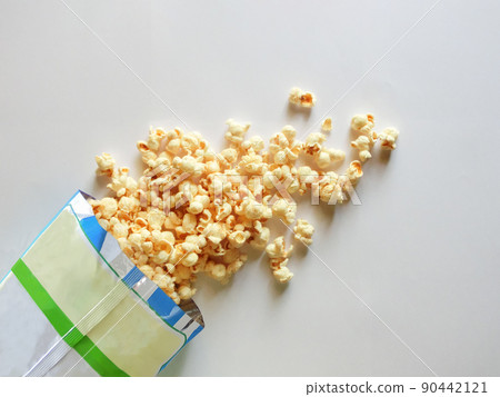 Popcorn out of the bag on a white background Popcorn out of the bag on a white background 90442121
