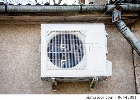 Air source heat pump, outdoor unit attached to the house wall 90445891