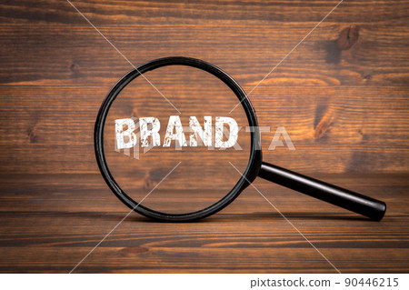 BRAND. Business concept. Black magnifying glass on a wooden background 90446215