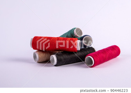 Thread spools in different colors on a white background Thread spools in different colors on a white background 90446223