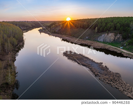 Beauriful sunset view along the Iset river and rocks near Kamensk-Uralskiy. A scenic sunset at the river. Kamensk-Uralskiy, Sverdlovsk region, Ural mountains, Russia. Aerial view 90446288