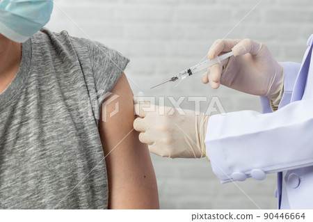 Hands of doctor or nurse hold a syringe and ampule preparing a shot of corona virus covid-19. Vaccination healthcare concept Hands of doctor or nurse hold a syringe and ampule preparing a shot of corona virus covid-19. Vaccination healthcare concept 90446664