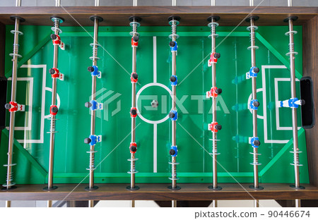 Top view image of plastic players in a table football game. Table football in the entertainment center. Top view image of plastic players in a table football game. Table football in the entertainment center. 90446674