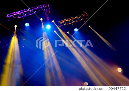 Crowd at concert - Cheering crowd in bright colorful stage lights 90447722