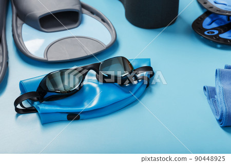 Sports equipment for swimming in the pool and open water on a blue background 90448925