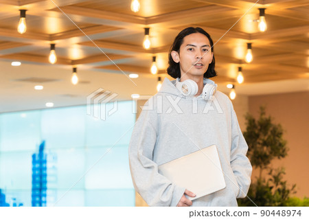 Men in headphones with a laptop Men in headphones with a laptop 90448974