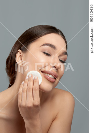 Woman Cleaning Face With White Pad. Beautiful Girl Removing Makeup White Cosmetic Cotton Pad. Happy Smiling Female Taking Off Makeup From Facial Skin With Cosmetic Pad. Face Skin Care. 90450456
