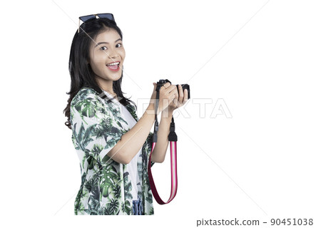 Asian woman with sunglasses using her camera standing 90451038