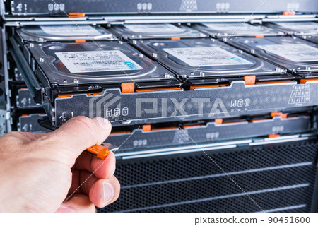 Cloud storage service, engineer pulling out panel and swapping hard drive disk hdd in server 90451600