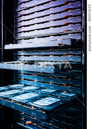 Cluster of hard drives inside open tray - a cloud data storage concept Cluster of hard drives inside open tray - a cloud data storage concept 90451633