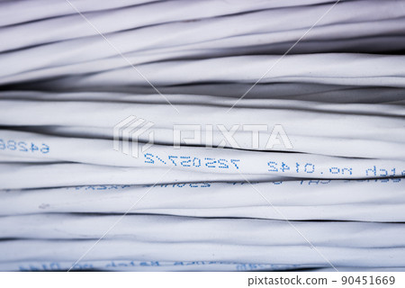 detail of large number of ethernet cables tied together connecting racks inside server room 90451669