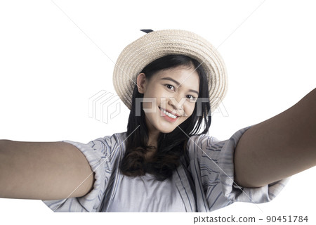 Asian woman with a hat taking a self-portrait 90451784