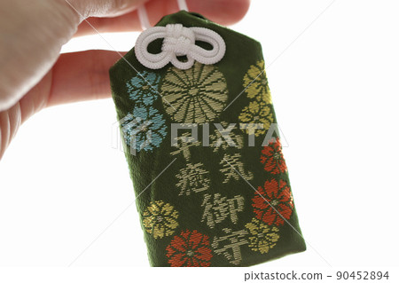 Hands holding a talisman for recovery from illness, Japanese talisman, prayer for good health 90452894