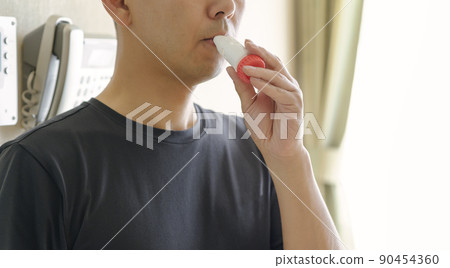 Men using asthma inhalers Men using asthma inhalers 90454360