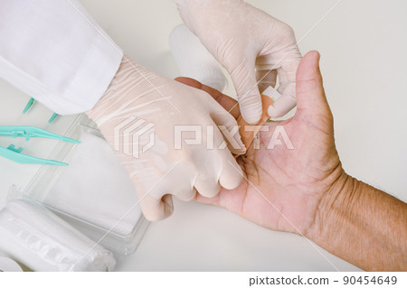 Doctor doing wound dressing care, Hand surgery treatment, Trigger finger stiffness painful 90454649