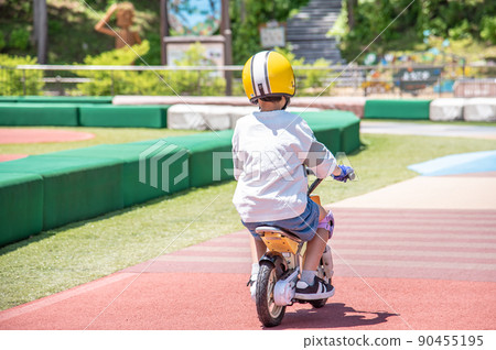 Elementary school boy riding a kids bike Elementary school boy riding a kids bike 90455195