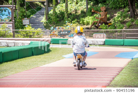 Elementary school boy riding a kids bike Elementary school boy riding a kids bike 90455196