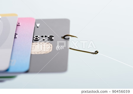 Credit card phishing scam concept. Credit card data theft, card hooked on fishing hook  90456039