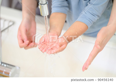 Toddler copy space to wash hands with mom Toddler copy space to wash hands with mom 90456140