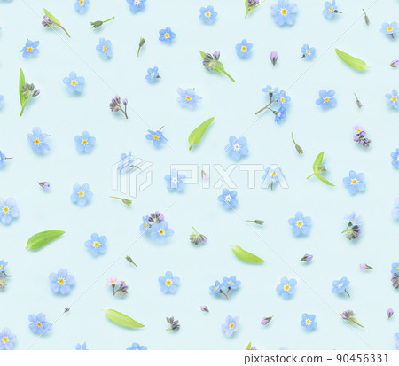 Seamless floral pattern of spring forget-me-not flowers buds and leaves on blue background top view 90456331