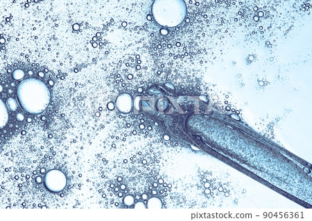 Cosmetic liquid dropper with serum in pipette with bubbles isolated on white background top view Cosmetic liquid dropper with serum in pipette with bubbles isolated on white background top view 90456361