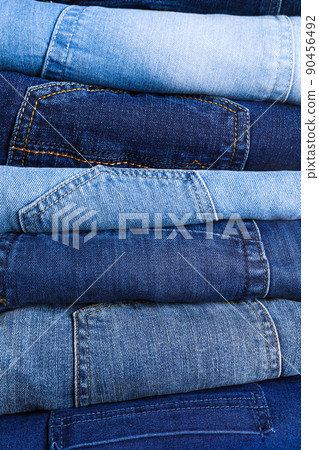 Stack of different jeans as background, closeup Stack of different jeans as background, closeup 90456492