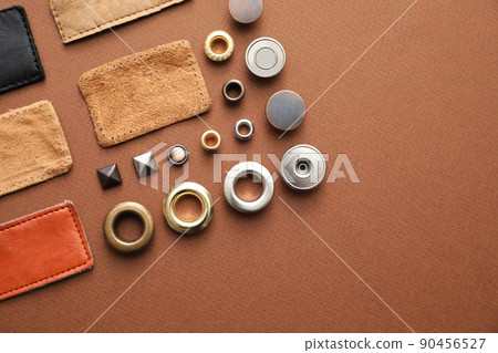 Flat lay composition with garment accessories for jeans on brown background 90456527