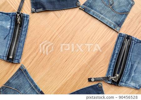 Frame made of jeans pockets on table, flat lay. Space for text 90456528